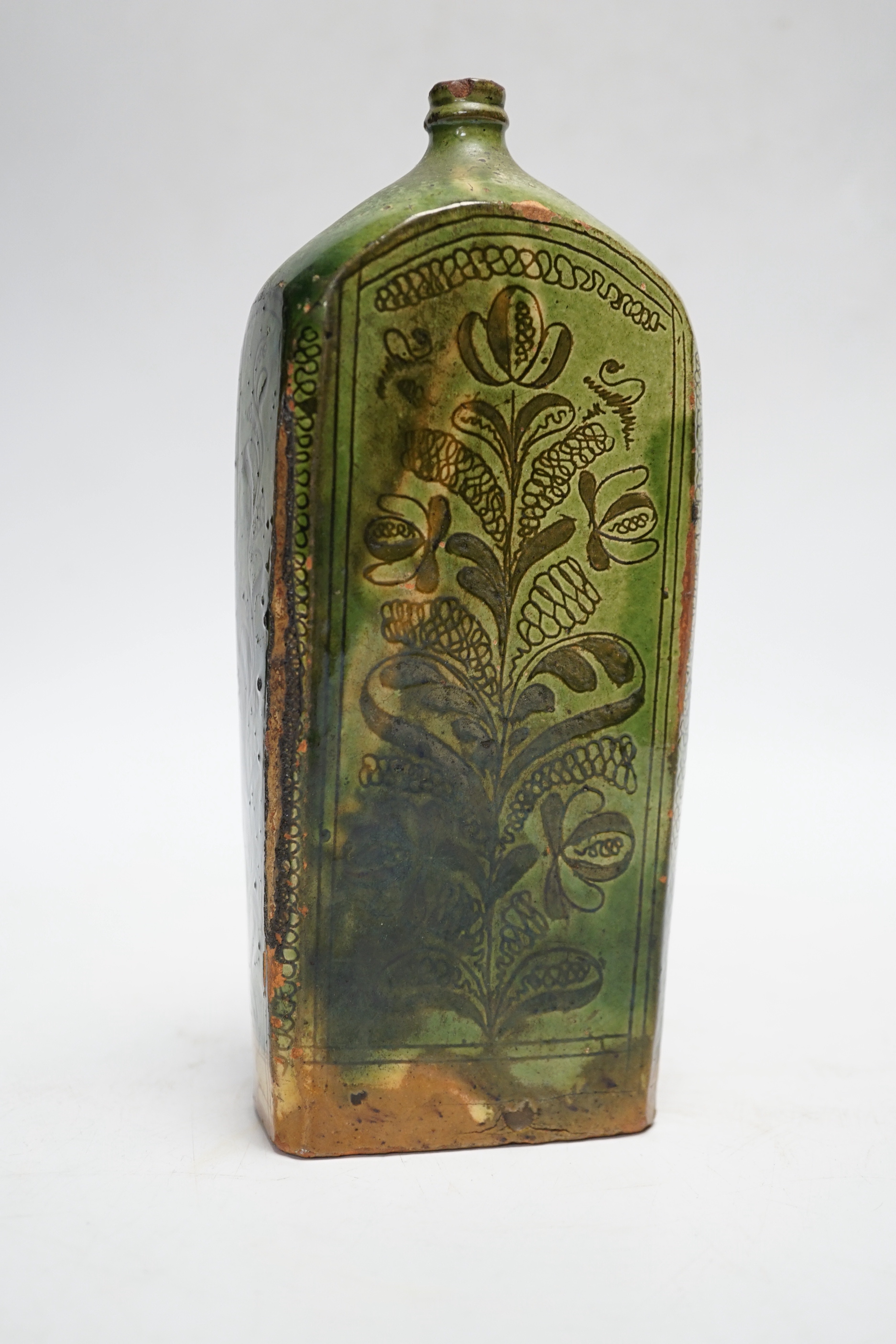 A 19th century green glazed terracotta sgraffito flask, 19cm